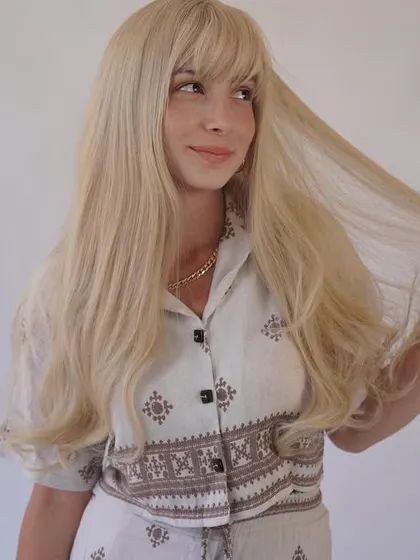 This client is showing off the length and quality of her 50-inch HD lace wig. Our custom pieces can be made to any desired length.