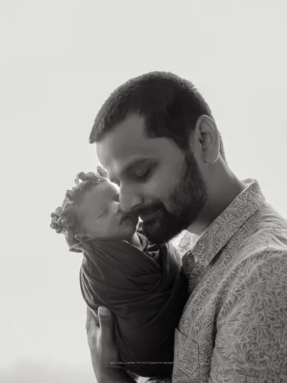 A quiet moment, a timeless memory. This black and white portrait of a father and his newborn is full of love and tenderness.