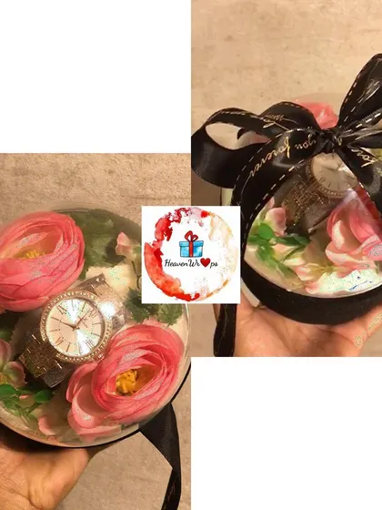 A creative way to gift a wristwatch. We placed this beautiful watch inside a clear bauble with artificial flowers and a decorative ribbon.