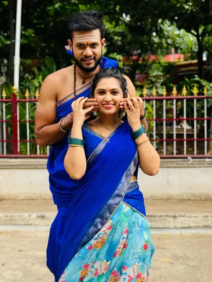 A fun and playful shot showcasing the beautiful blue half saree, a modern take on traditional attire.