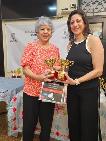Naheed Divecha and her partner after winning the veteran doubles title, proving that passion for the sport has no age limit.