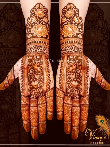 A beautiful short-hand design with intricate floral patterns covering the palms and wrists. The symmetry and detail make it a very elegant choice.