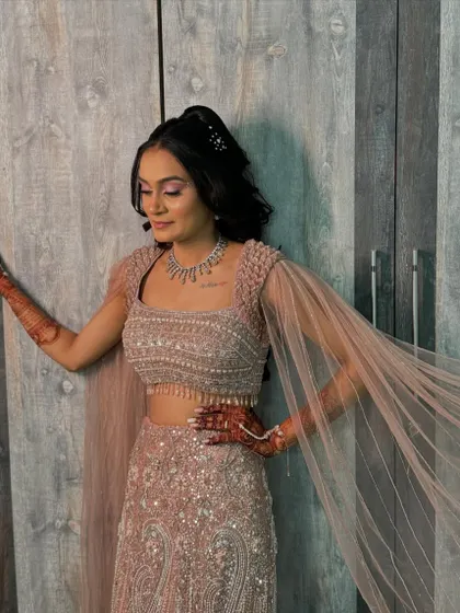 The flowy cape sleeves of her outfit add to the drama of this stunning sangeet look.