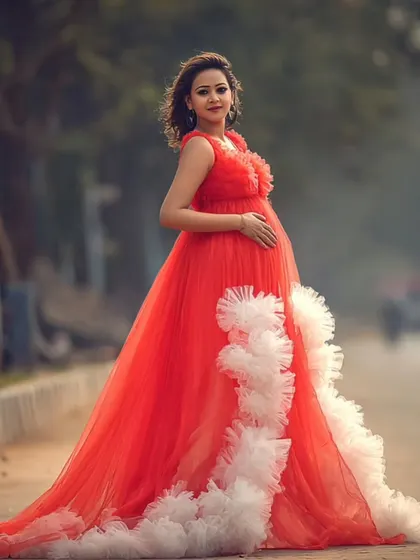 When grace meets boldness. This modern muse slayed her outdoor maternity shoot in a flowy, fire-red couture gown.