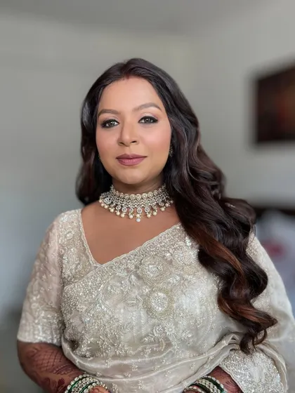 A portrait of the final look, with makeup that enhances her features beautifully.