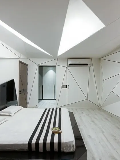 We pushed the boundaries of bedroom design with this deconstructivist concept. The interplay of geometric lines on the walls and ceiling creates a dynamic, sculptural space, while the monochrome palette maintains a sense of sophisticated calm.