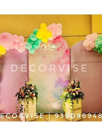 For a modern and chic baby shower, we created this pastel-themed backdrop. It features elegant arched panels with a watercolour finish, an "Oh Baby" sign, and organic balloon arches in a soft, playful colour palette.