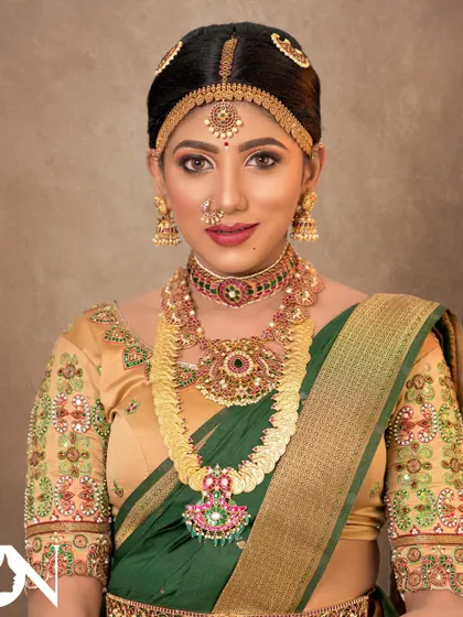 This bride looks confident and beautiful in her complete bridal attire. The temple jewellery set adds a touch of divine grace to her overall look.