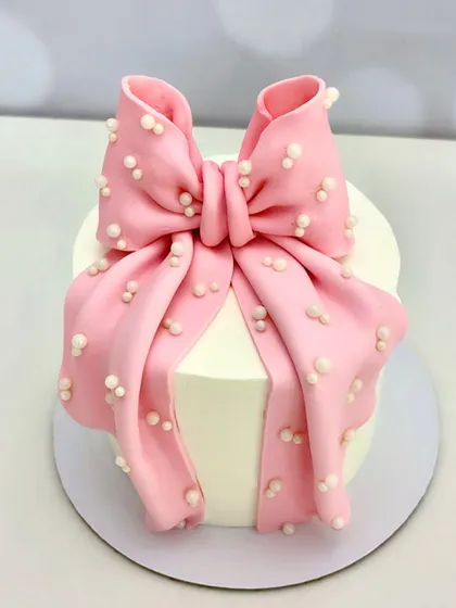 Why stop at wrapping the gift when the cake can come wrapped too? This elegant bow cake is ideal for bridal showers, birthdays, or any special moment.