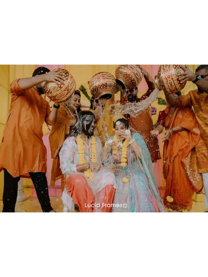 A fun ritual where the couple is showered with water and petals by their friends.
