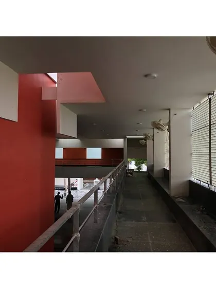 A view of the corridor in the Sai Temple, with a bold red wall adding a vibrant spiritual accent to the space.