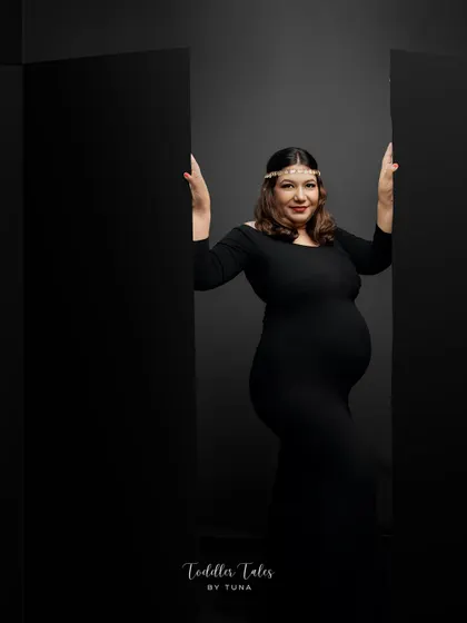 Strength and elegance combined. This portrait in a simple black gown uses strong lines and a confident pose to create a timeless and powerful image of motherhood.