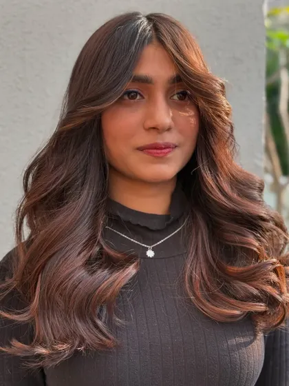 Soft, bouncy waves in a warm brown shade. This is a timeless look that combines a great haircut with a color that enhances natural beauty.