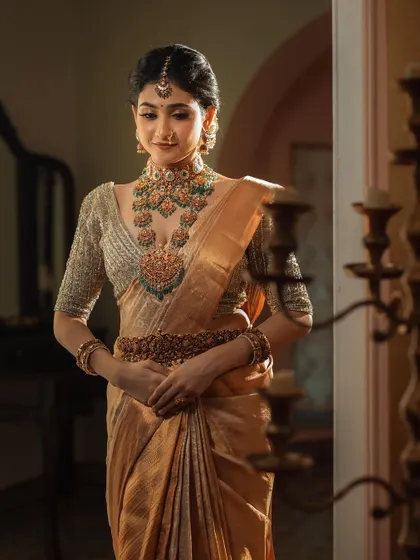 A classic seated portrait of a bride, her beautiful golden saree and intricate jewelry shining in the soft light. This is a duplicate of ID 8.