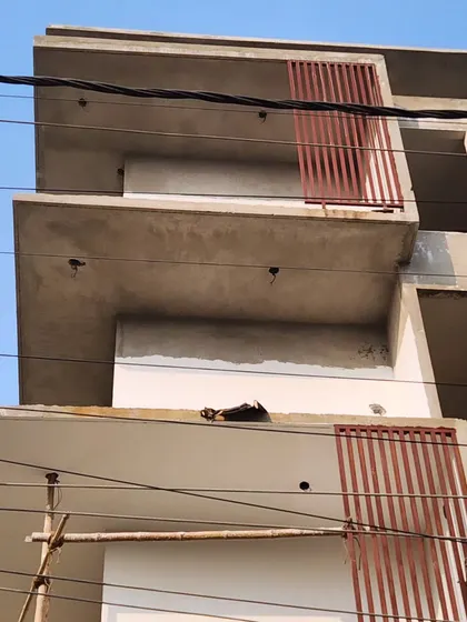 Another angle showing the simple, clean lines of the concrete balconies before the final finishing, plastering, and painting.