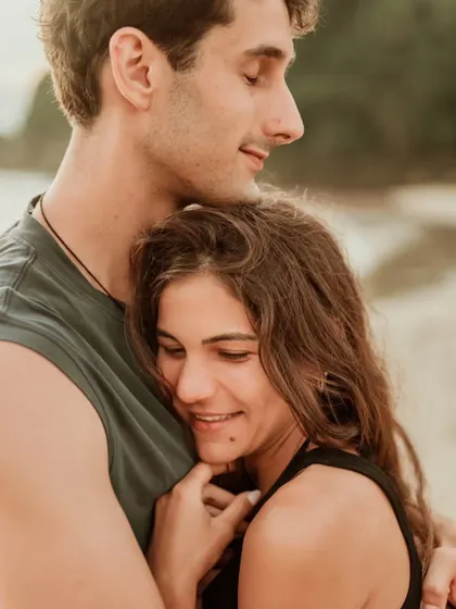 A close, affectionate hug on the beach, capturing a moment of comfort and love. This intimate portrait is a beautiful memory from their Bali pre-wedding shoot.