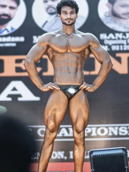 A front relaxed pose on the competition stage. This pose is crucial for making a good first impression on the judges and showcasing your overall structure.