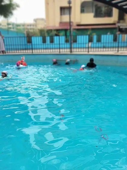 A blurry, action-filled shot of our swimming class, capturing the dynamic and fun atmosphere in the pool.
