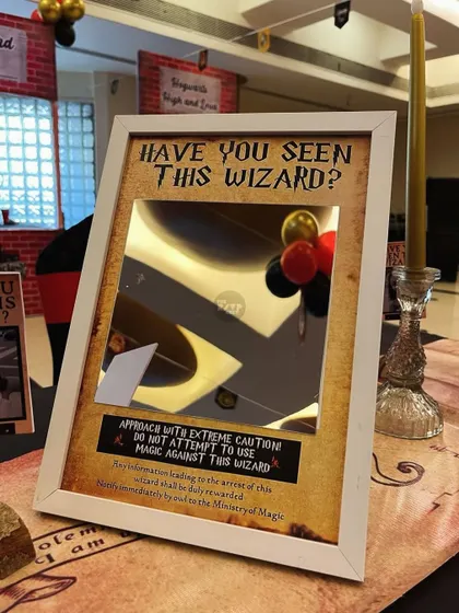 A fun, interactive mirror where guests can see themselves in a 'Have You Seen This Wizard?' poster.