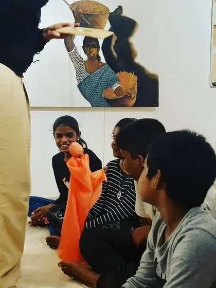 Using different types of puppets, including sock puppets, to engage children during a fun and interactive workshop.