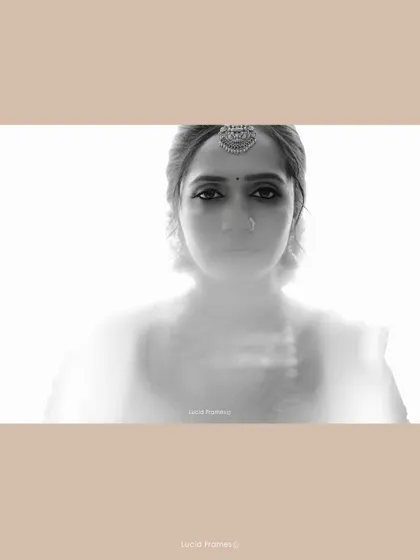 An artistic, ethereal black and white portrait of a South Indian bride, using soft focus to create a dreamlike quality.