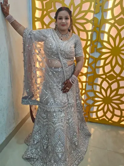 This heavily embroidered silver-grey lehenga is a stunning choice for a reception or engagement. The intricate threadwork and pearl detailing offer a modern yet regal feel.