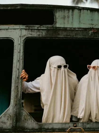 A quirky shot of the "ghosts" peeking out of an old, abandoned bus.