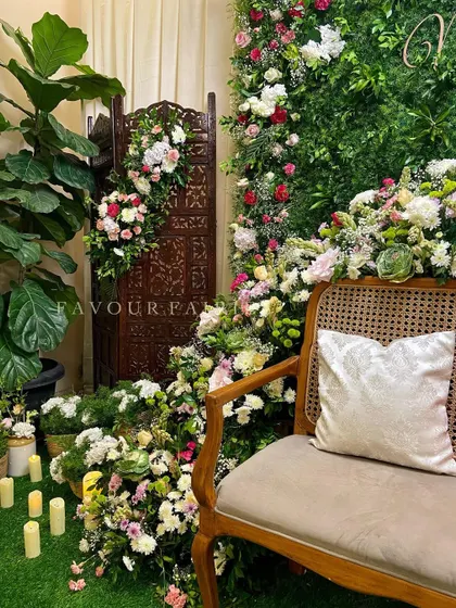 Another view of the botanical garden baby shower, showing how we used potted plants, candles, and a carved wooden screen to create a lush and layered look.