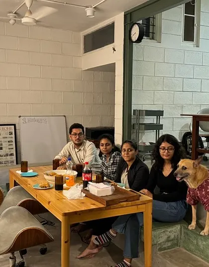 Glimpses of our team at the studio. We foster a collaborative and fun environment where ideas are shared openly, often with our furry studio manager keeping a watchful eye.