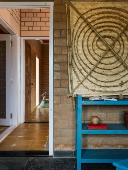 This corner in the EESHA house features repurposed and handcrafted decor against the honest backdrop of CSEB walls, celebrating sustainable and artistic choices.