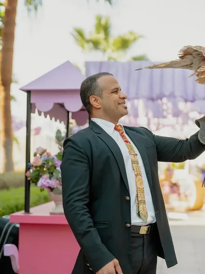 A guest poses with a falcon, embracing the local culture and adding an element of adventure to the wedding festivities.
