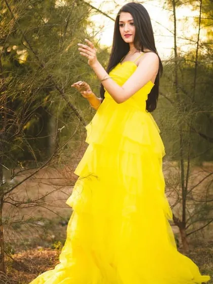 The movement and light texture of the yellow tulle gown are captured in this shot. It's an excellent rental option for creating a fresh and vibrant look for a portfolio.