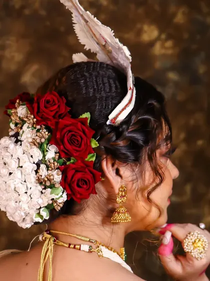 A full view of the intricate floral bun we created for this Bengali bride. The combination of red and white flowers is a timeless choice.