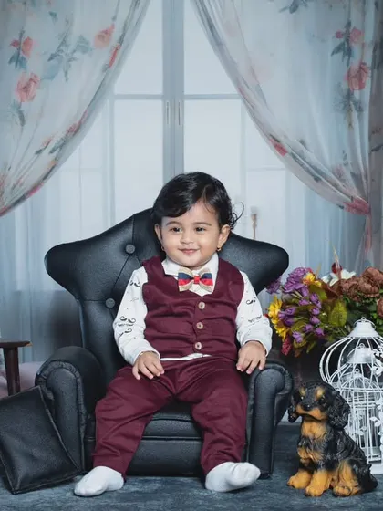 A stylish toddler in a three-piece suit, looking like a little gentleman.
