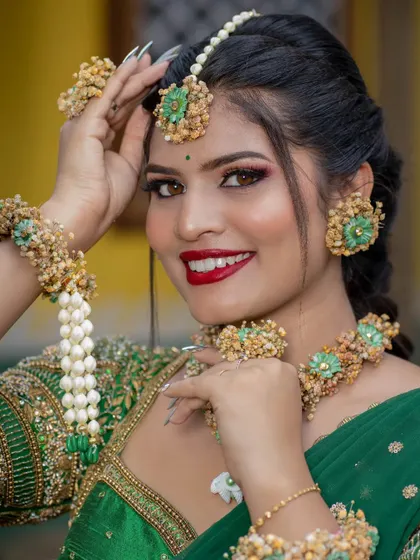A joyful bridal portrait. The bright red lip and sparkling eyes perfectly capture the celebratory mood of a wedding.