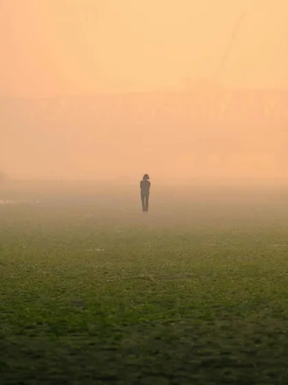 A minimalist and atmospheric shot of a solitary figure walking through a foggy field. This image was featured in my photographer spotlight.