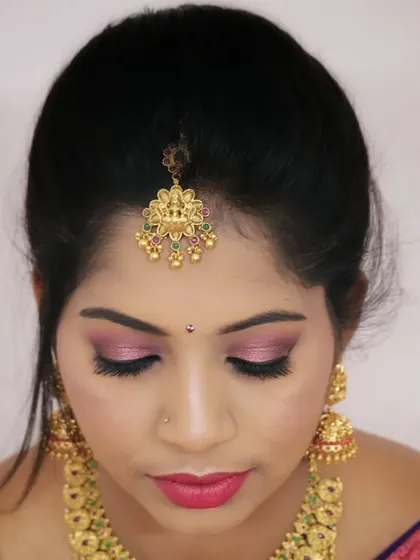 A close up of the soft pink eyeshadow, which adds a touch of modern romance to a traditional look.