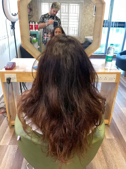 The "before" shot, showing the client's hair prior to the transformation.