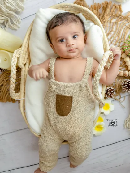 Another beautiful shot from a boho newborn session. The natural materials and neutral color palette create a calm and earthy feel, perfectly complementing the baby's pure and innocent spirit.