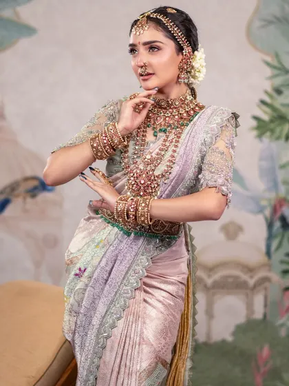 A graceful pose that showcases the full bridal look. The hand-painted studio backdrop adds an artistic and unique element to this traditional portrait.