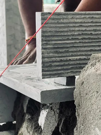 A collection of images and videos documenting various stages of construction, from site visits and foundation work to the detailed installation of architectural fittings and finishes.