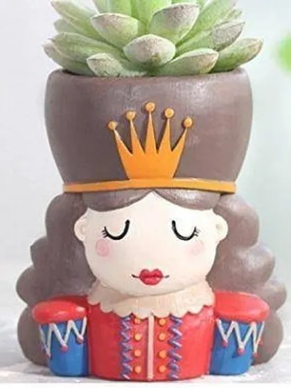 This is the Queen Nutcracker version of our resin planters, a perfect match for the King. They make a great pair on any shelf or table.