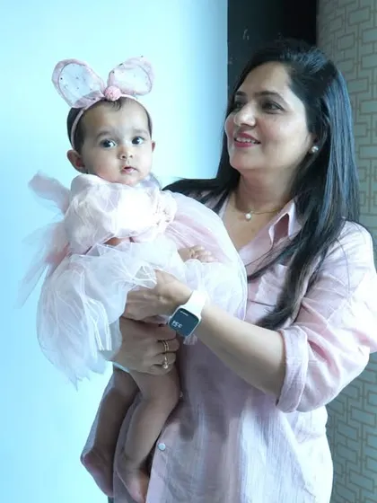 A beautiful portrait of a mother holding her baby, both looking serene and connected. These lifestyle photos are perfect for capturing authentic family moments at home.