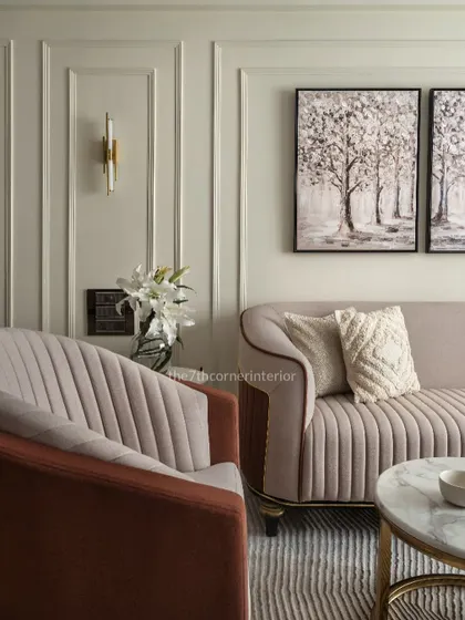 A detail shot showing the fluted upholstery of the custom sofa and armchair. The combination of textures and curved forms adds a layer of sophistication and comfort to the living space.