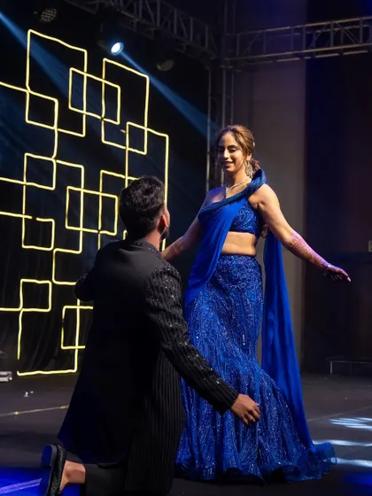 A romantic moment from the couple's Sangeet dance. The bride's stunning blue saree-gown was perfect for the performance.