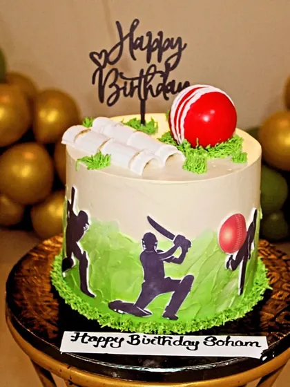 A cricket-themed cake for a 10th birthday, complete with an edible ball, bat, and wickets.