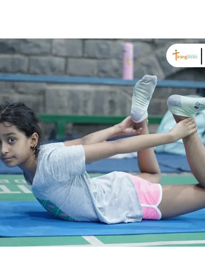A young player practices the Dhanurasana (bow pose) during our yoga day event. Yoga helps improve flexibility and core strength, which are vital for preventing injuries in badminton.