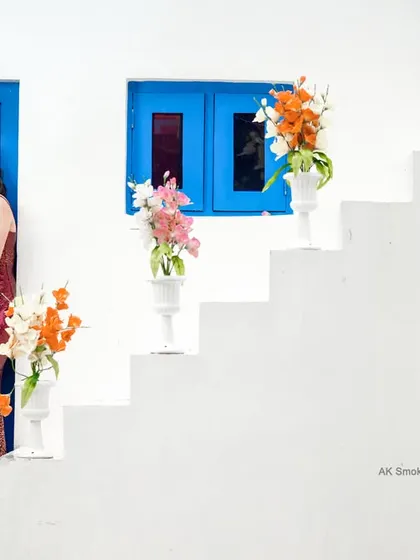 A stylish portrait on the steps of the themed set, showcasing the couple's elegant attire.