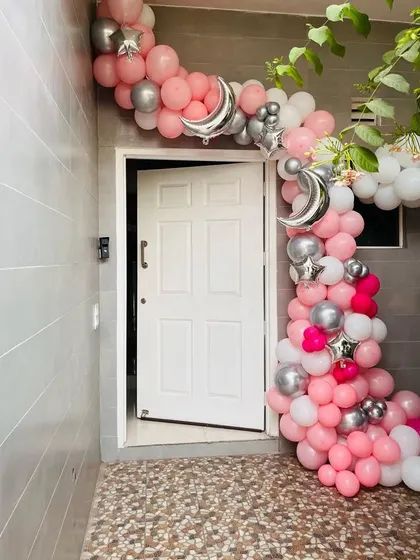 Make the welcome special right from the front door. I created this beautiful balloon arch in shades of pink, white, and silver with moon and star accents to greet the family.