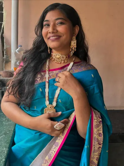 Our customer looks absolutely radiant in this elegant Meenakari and pearl set. The combination of the choker and the long pearl mala creates a look that is both traditional and modern.